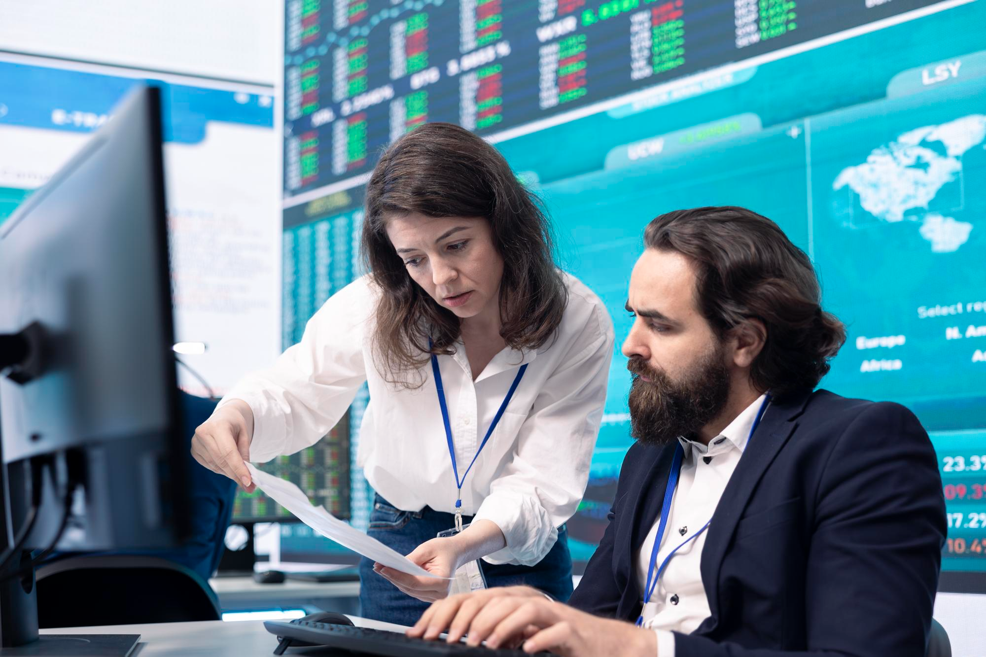 Banking analysts reviewing financial data on trading screens