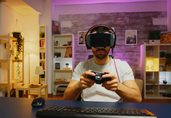 Player using a headset and controller at a gaming desk