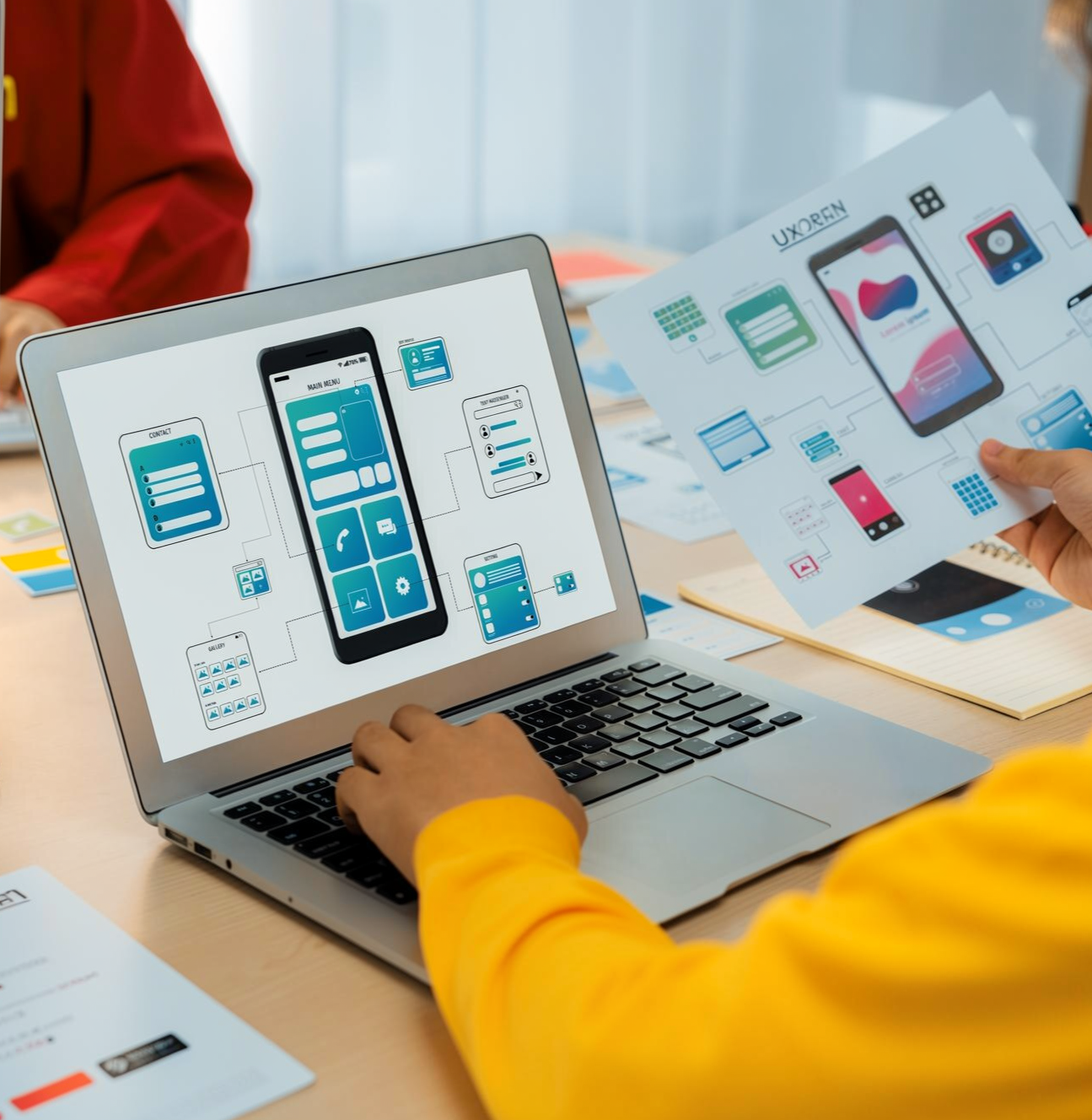 Designer mapping progressive web app screens across desktop and mobile